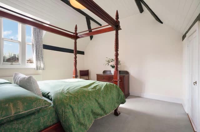Four-poster bedroom with exposed beams