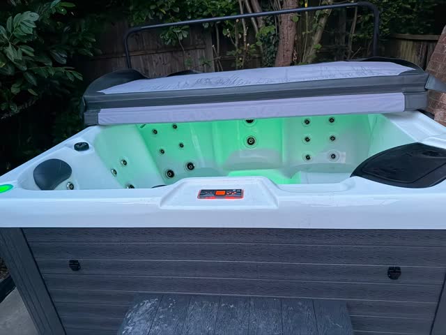 Private hot tub lit up in the evening